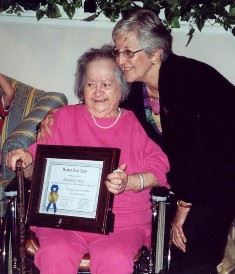 Past Chair Shirley Mosczynski presenting Philomene Fanny Yacio with her certificate in August 2004